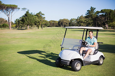 快乐的高尔夫球员驾驶高尔夫大鼓图片