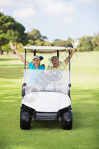 坐在高尔夫大鼓中快乐的一对高尔夫球员夫妇图片