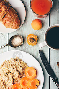 粥加杏仁 咖啡 果汁和羊角面包勺子麦片燕麦浆果饮食高架饮料食物糕点橙子图片