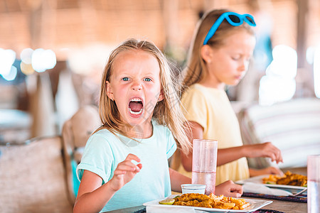 可爱的小女孩在户外咖啡厅吃早餐金发婴儿咖啡店瓶子西瓜假期海滩女儿蜂蜜橙子图片