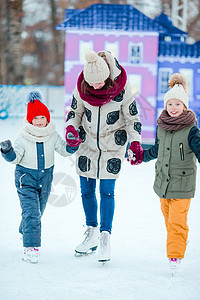 家庭滑冰 母亲和孩子在冬天学会滑冰 (双亲学习冬季滑冰)图片