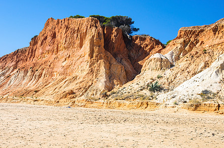 Falesia海滩的红色悬崖橙子假期侵蚀编队海岸线海洋蓝色地质学天空旅行图片