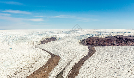 飞机从格陵兰的冰盖融化冰层空中观察流动天线冰川生态顶峰全景峡湾警告床单场地图片