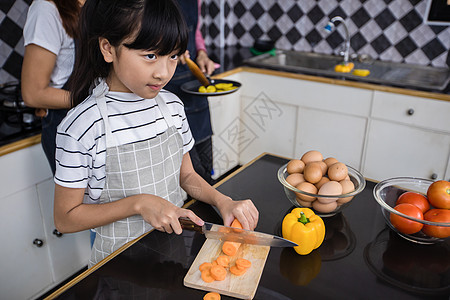 亚裔家庭正在做饭 家长在教他们游泳乐趣成人蔬菜孩子们女儿父母童年父亲女孩午餐图片