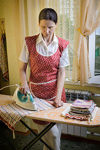 在厨房里打铁女人工作工人房间散热器织物熨烫母亲衣服茶巾木板图片