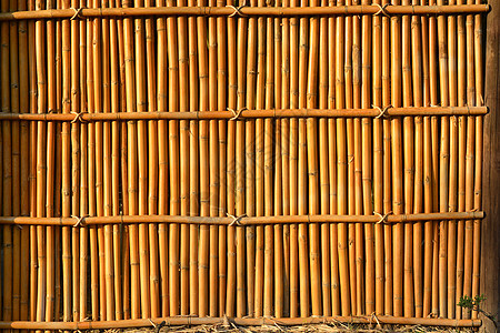 泰国风格的竹屋墙风化材料条纹框架枝条木材地面热带装饰绑定背景图片