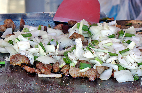 烤肉和洋葱在金砖上炙烤香料胡椒食物韭菜油炸烹饪背景图片