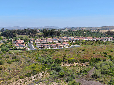 上中中产阶级社区与绿谷居民住宅的空中景象图不动产景观邻里细分房子住房城市富裕草地风景图片