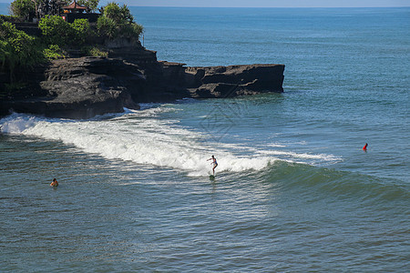 冲浪者在波浪中 抓住波浪 在管道中冲浪 在巴厘岛的海洋中冲浪 一个醇厚的男人 一个纵身跳入大海 从水中取出 从水中拍摄海滩乐趣力图片