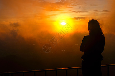 一个女人的影子 站着看雾和日出女性阳光天气女孩衬衫薄雾国家公园自由天空图片