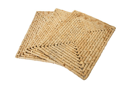 在白色背景上隔离的柳条餐垫手工稻草厨房材料编织棕色风格装饰纤维图片