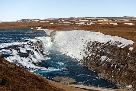 冰岛的瀑布蓝色岩石壁架倒台流动冰川悬崖远足遗产图片