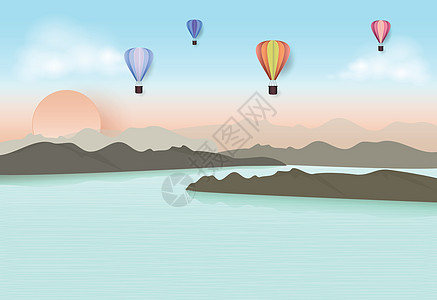 热气球在蓝天穿梭于湖和山上图片