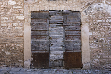 意大利卢卡市古老的旧木制门和铜柄图片
