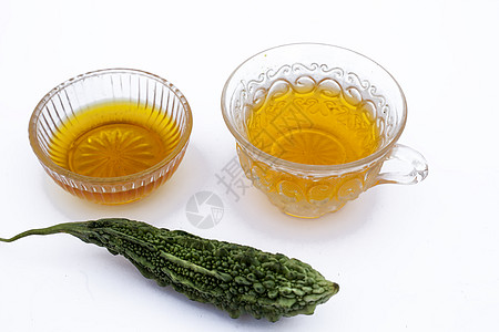 白色分离的流行排毒凉茶 即与蜂蜜及其成分分离的苦瓜或苦黄瓜茶桌子饮料黄瓜杯子绅士饮食重量薄荷香脂损失图片