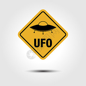 UFO 黄金属标牌 上面有刻着字和一张UFO的图片图片