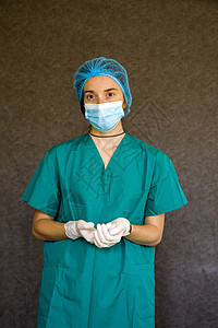 医生或护士表格 穿医疗制服 戴面罩 手套和外科帽的妇女肖像面具预防前线防护服手术女性专家诊所医院口罩图片