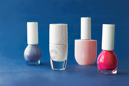 深蓝色背景 美容品牌的奈光油瓶子液体指甲油指甲博客修脚美丽美甲推广粉色塑料背景图片