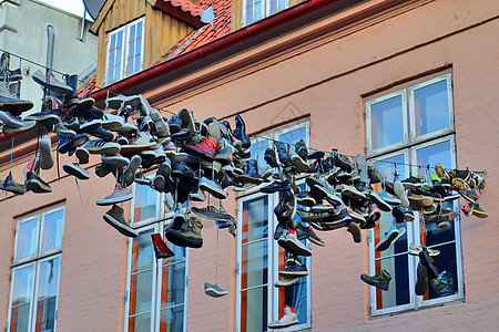 在德国最北边的小镇 名叫弗伦斯堡的老房子之间挂着鞋子蓝色运动鞋细节艺术品金属建筑学建筑物阳光生活建筑图片