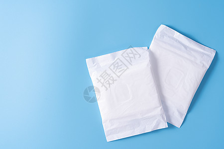 卫生巾 蓝色背景的卫生巾 月经 女性卫生 顶视图软垫女孩妇科内衣棉布水分尿布产品吸水性小样背景图片