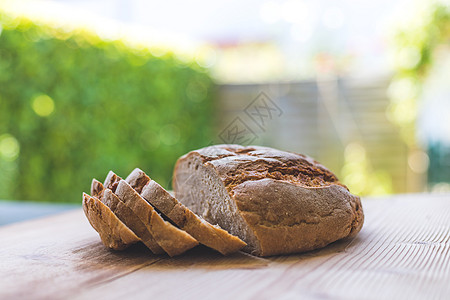 木制切纸板上新生的面包 布蓝皮背景营养早餐食物烘烤饥饿面粉烹饪砧板乡村脆皮图片