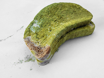 白色背景孤立的一块面包 上面盖着绿色模子病菌生物学生物微生物食物霉菌模具孢子细菌生长图片