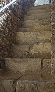 在古老的托曼堡垒地下楼梯上的旧石头太阳地标脚凳材料地下室历史阳光岩石入口历史性图片