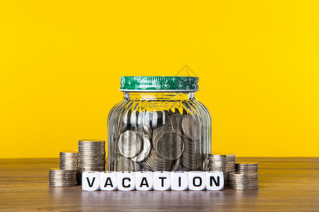 在有黄色背景的玻璃罐中有很多硬币 保存假期概念商业预算保险股利退休财富现金金融生活经济图片