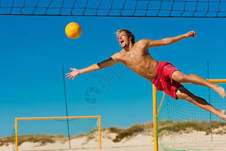 海滩排球  男人跳跃说谎防御保卫运动运动员潜水成人球赛乐趣竞赛图片