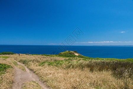 在阳光明媚的一天在菲利普岛远足悬崖海岸线空间海滩自行车小路海洋旅游蓝色衬套背景