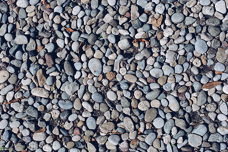 小鹅卵石的背景纹理岩石花园鹅卵石灰色石头墙纸路面花岗岩矿物碎石图片