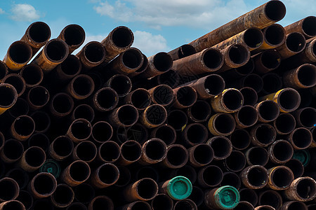 一堆旧的生锈圆形金属工业管 在工厂仓库的钢管堆 工业材料 金属腐蚀 一堆生锈的管子 在仓库的旧铁管 金属管业团体生产氧化物圆圈几图片
