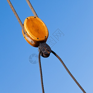 蓝色天空中的木质电缆滑轮操纵细节图片