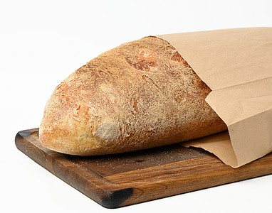 木板纸袋上用白面面粉制成的全烤面面包图片