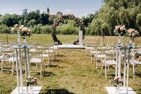白俄罗斯内斯维日城堡附近的绿草坪上街道的婚礼仪式城堡报名安装风格组织鲜花装饰国家草地婚姻图片