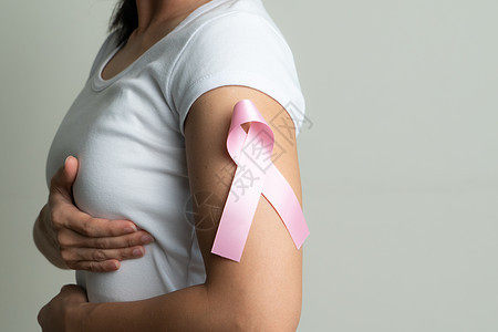 妇女手臂上的粉色徽章丝带 以支持乳腺癌的致癌原因乳腺癌认识概念手术治愈帮助机构治疗保健外科卫生幸存者信仰图片