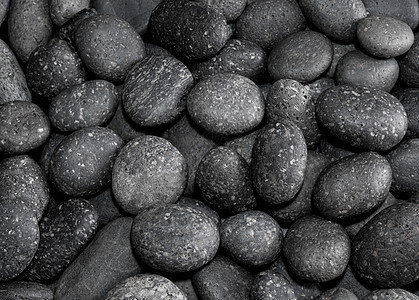 干圆灰河石背景的质地棕色岩石材料卵石圆形黑色海绵状自然灰色图片