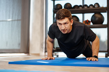 年轻运动运动员在健身房做俯卧撑 关上门力量地面身体体操海报锻炼体育锻炼活动活力成人图片