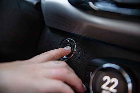 在现代汽车中按下启动停止按钮 特写 没有脸部 有选择的焦点图片
