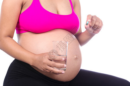 检查孕妇手上装有水杯和长吻避孕药的近身成人玻璃女士药品治疗药片母性维生素药物白色图片