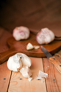 白色木桌上的蒜瓣和大蒜鳞茎图片