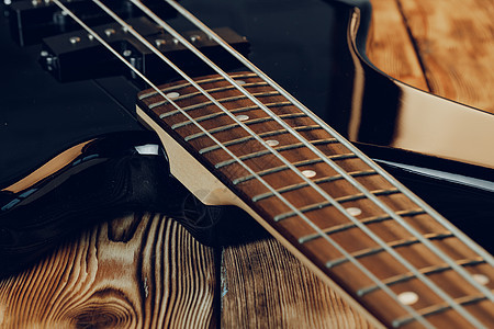 电动吉他手指头贴近照片低音工作室黑色乐器音乐指板木头谐振身体岩石背景图片