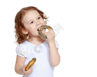 小女孩吃百吉饼小吃厨师烹饪孩子帽子婴儿糕点微笑面包师包子图片