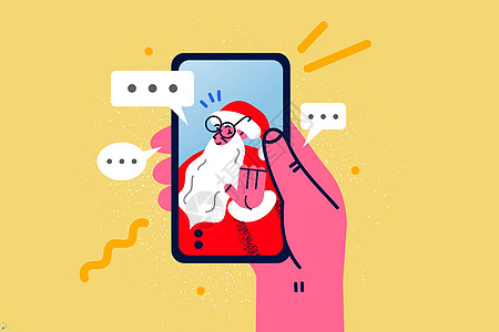 与圣诞老人用手机进行视频电话交谈的人图片