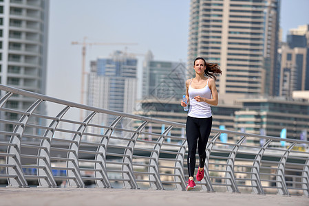 妇女清晨慢跑女性运动运动员活动跑步公园训练赛跑者运动装城市图片