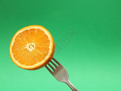 叉子上的橙色健康水果美食甜点植物饮食营养小吃热带食物图片