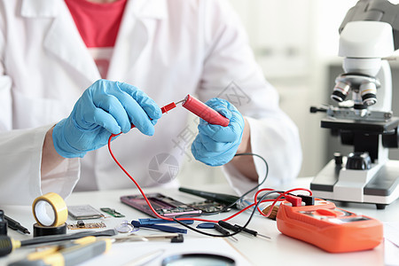 使用测试器闭合检查电池电荷的总修理师技术员电缆收费实验作坊测量电工控制技术修理工图片