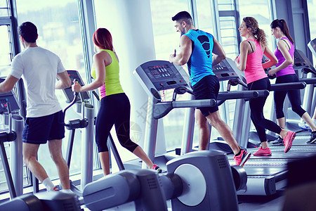 一群人在跑步机上奔跑训练跑步团体男性赛跑者体育馆女孩男人健身运动图片