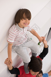 年轻男孩在顶层风景上排成一列木地板团体男孩们孩子生活乐趣架子冒充家庭兄弟图片
