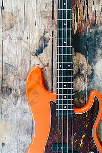 木本底的橙色电贝斯吉他音乐旋律爵士岩石乐器爵士乐棕色吉他手钢弦音乐家图片